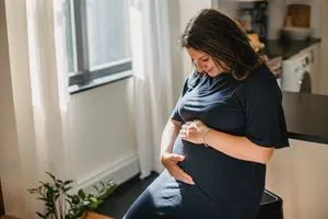 A pregnant woman by a window